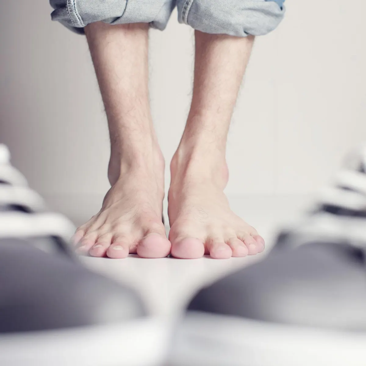Bare feet standing on a light floor